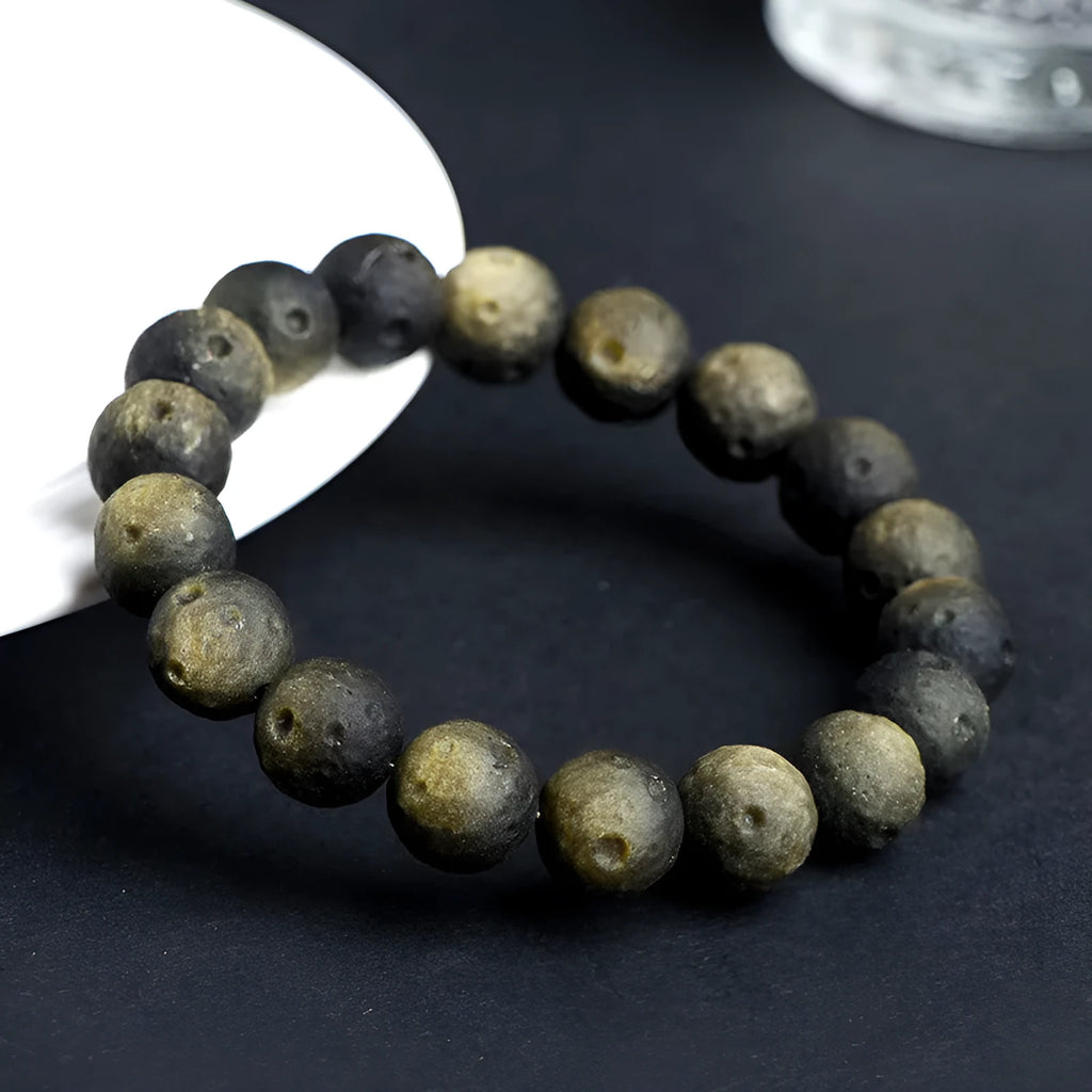 Natural crater ball bracelet featuring gold obsidian and silver stone meteorite beads in various sizes from 9mm to 16mm