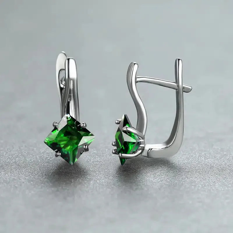 A pair of women's copper earrings with an inlaid zircon diamond design, shown in blue, green, and colour variations.