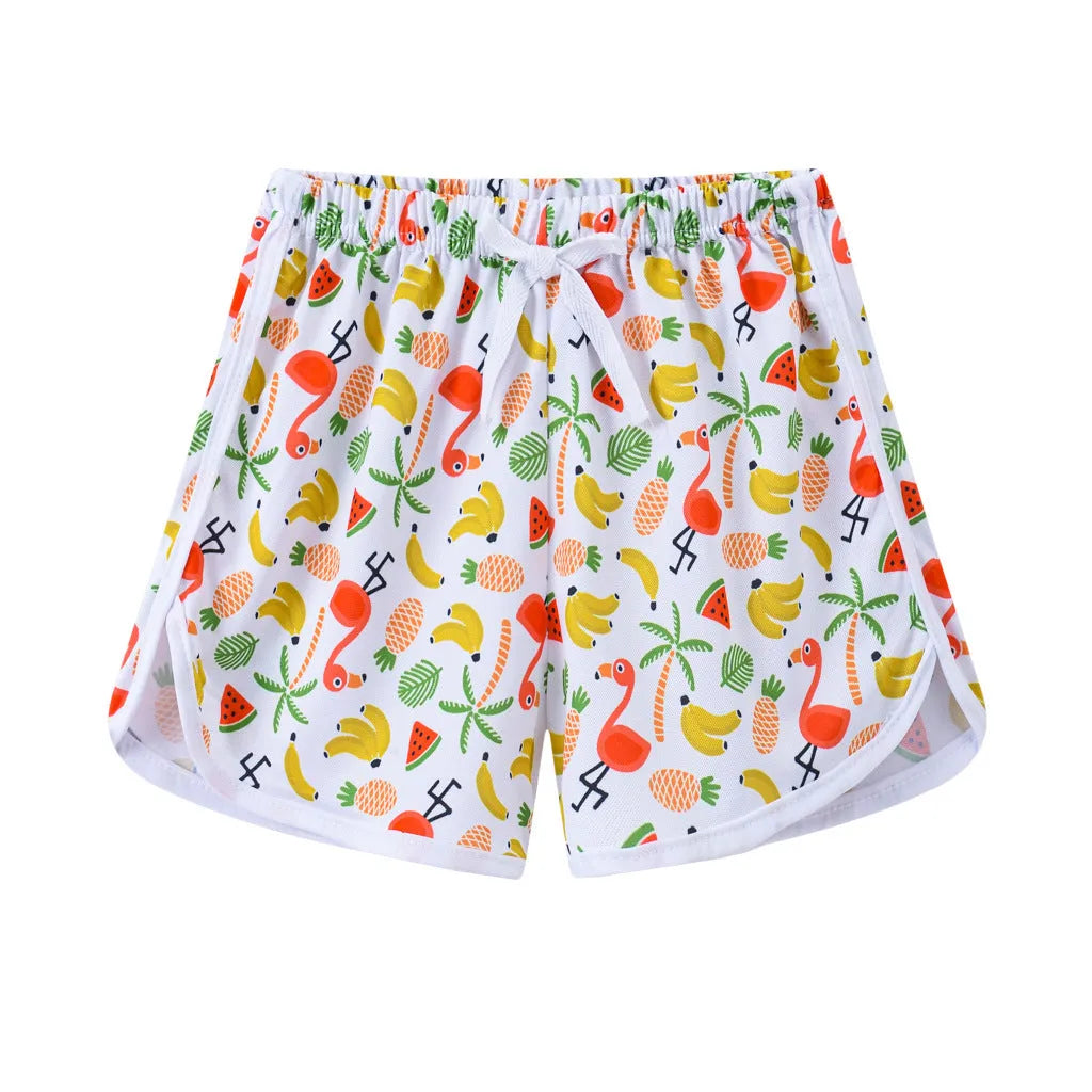 Children's patterned beach shorts in various colours including leopard print, floral, and fruit designs