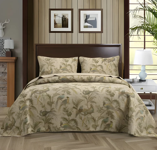 Blue American floral and bird print cotton quilted bedspread set with matching sheet on a bed.