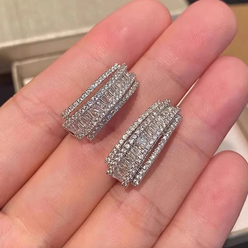 Geometric white gold colour stud earrings with zircon detailing on copper