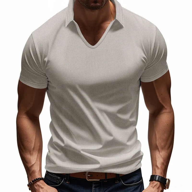 Man wearing a loose-fit apricot coloured V-neck short sleeve cotton blend T-shirt.