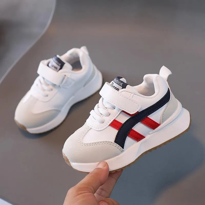 Children's white synthetic leather sneakers with Velcro fastening and a rubber sole