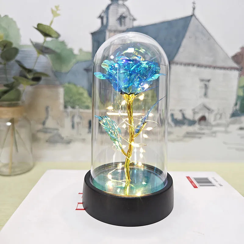 Small plastic night lamp with floral decoration and coloured light options on a black base.