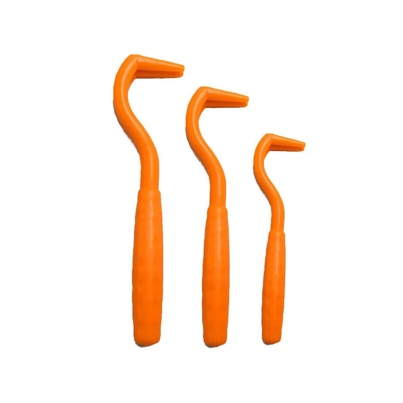 Set of three coloured plastic tick hook removers for dogs on a white background.