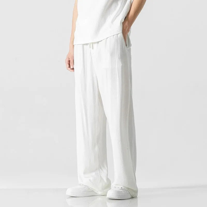 Men's beige linen casual trousers with a loose straight-leg fit and drawstring waist.