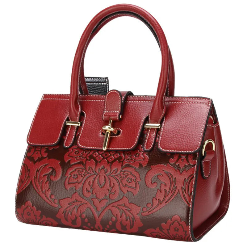 Red genuine leather oval crossbody bag with embossed design and multiple interior pockets