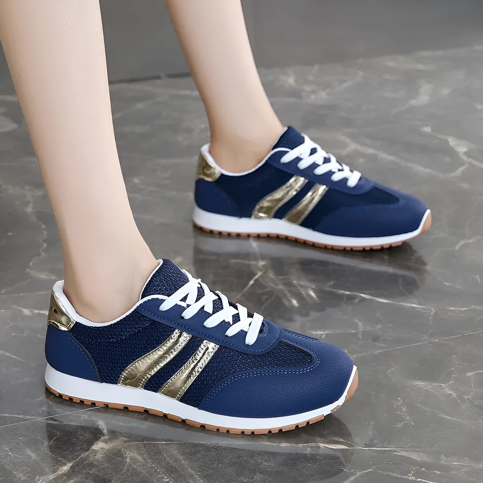 Blue women's lace-up tennis shoes with cross shoulder straps and a flat rubber sole.