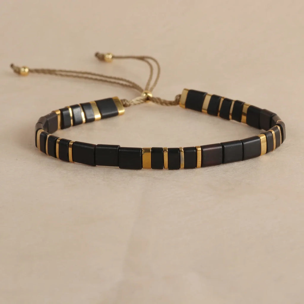 Geometric beaded pull-on bracelet in milky white, black, green, blue, or red colours