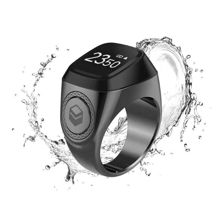 Zikr1 smart ring in black, green, rose gold, or silver on charging case with OLED display showing dhikr count.