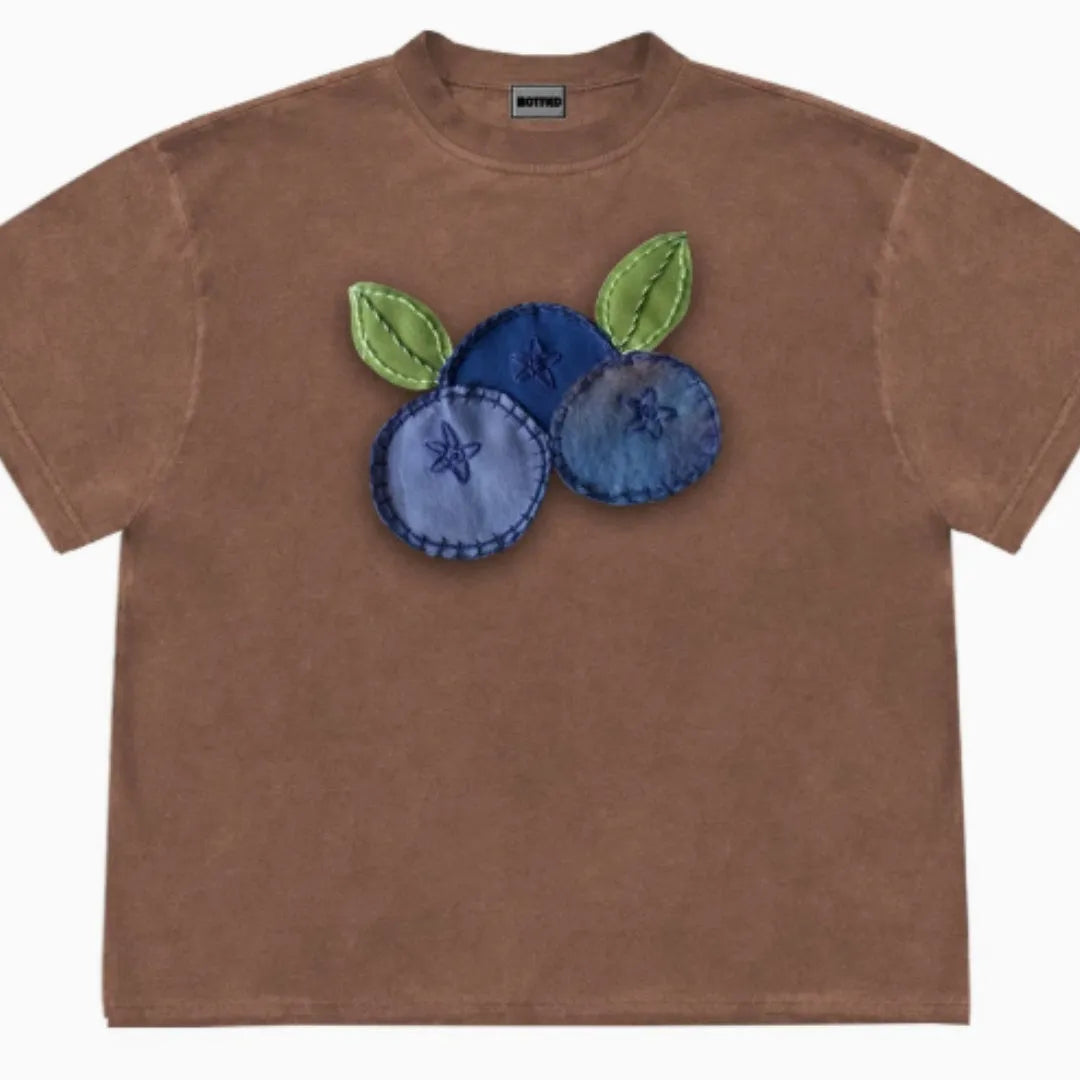 Blueberry patchwork short sleeve t-shirt in ice oxygen cotton, shown in dark coffee colour with plant and flower pattern.