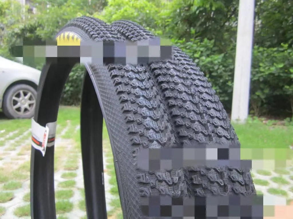 Ultralight puncture resistant mountain bike tyre shown in multiple sizes including 26, 27.5, and 29 inch diameters.