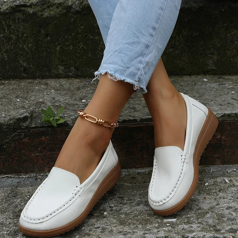 Women's PU leather flats loafers in round toe design with car suture detailing on upper