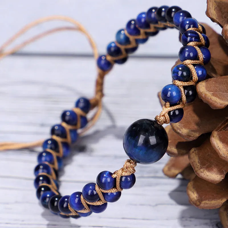 Handmade woven bracelet with geometric pattern in blue tigereye stone beads and pull closure.