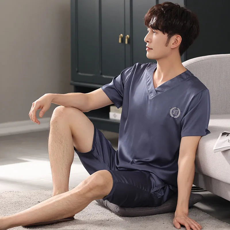 Man's light blue ice silk pyjama set with short sleeves and loose shorts laid flat.