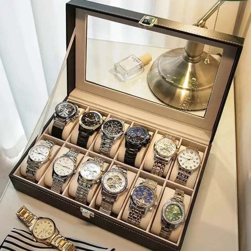 Grey leather watch storage box with transparent lid showing multiple watch slots inside