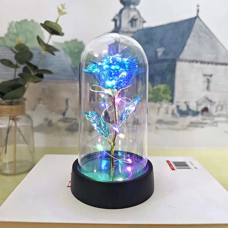 Small plastic night lamp with floral decoration and coloured light options on a black base.