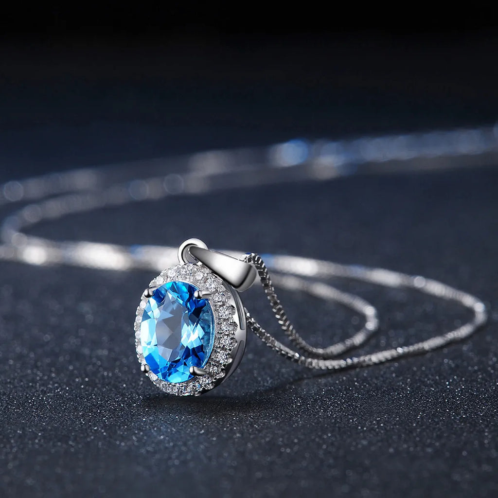 Geometric design 925 sterling silver jewellery set with blue topaz, showing earrings, ring, pendant and necklace.