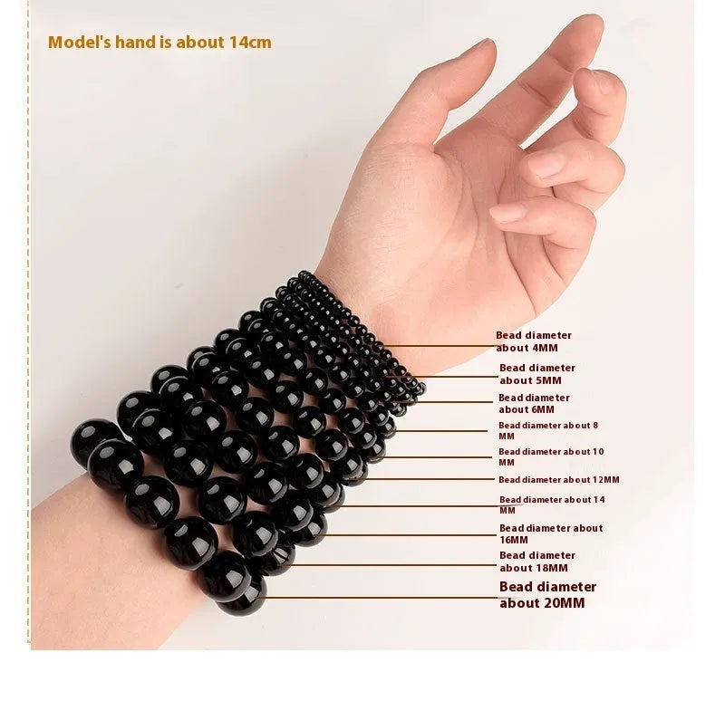 Smokey violet Hetian jade straight cut bead bracelet on a wrist.