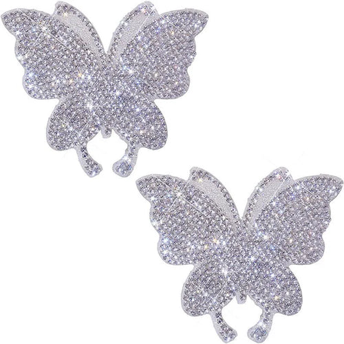 Close-up of a diamond-encrusted glass car sticker in a butterfly or bear claw design on a white background.