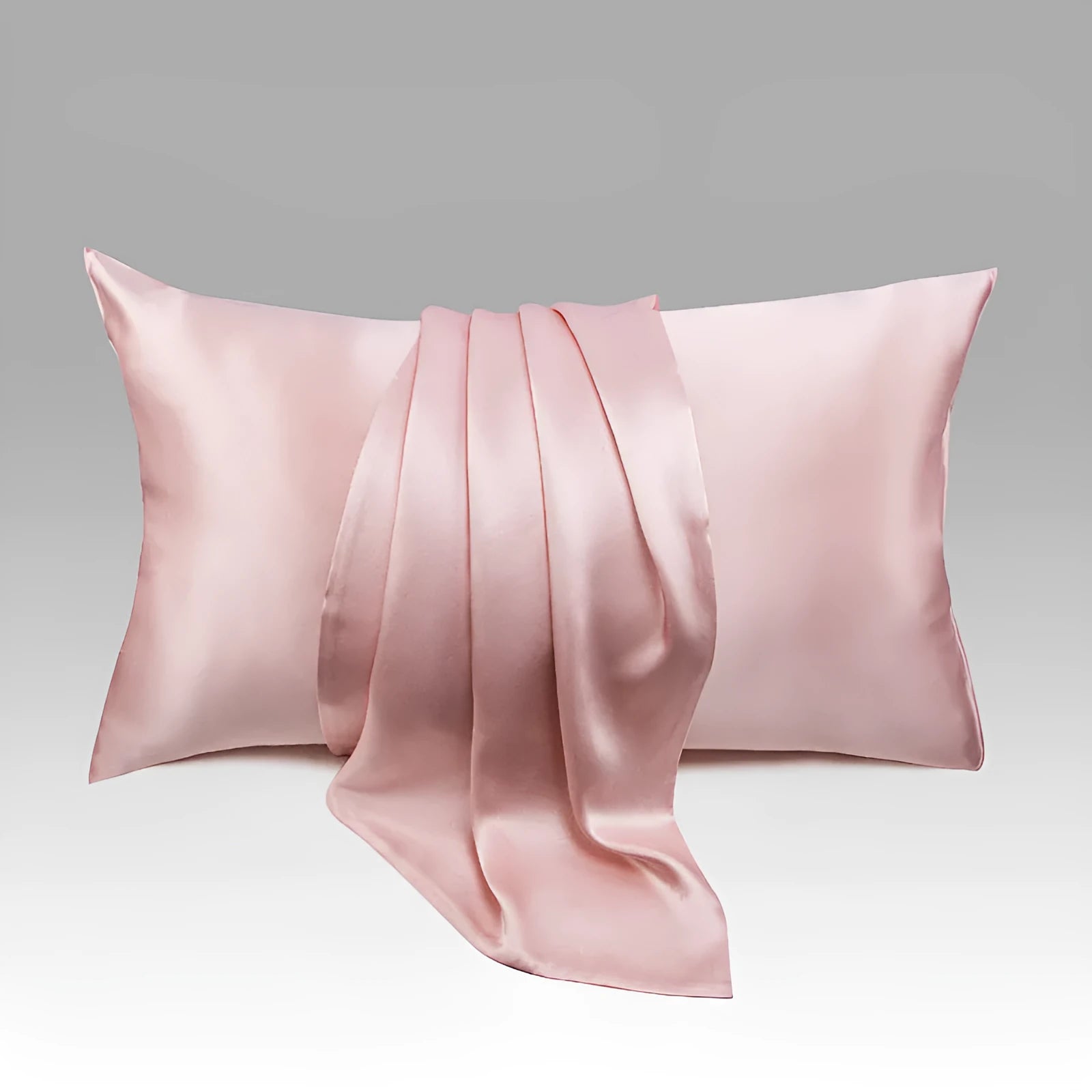 Dark grey silk pillowcase with envelope closure, shown flat and on a pillow.