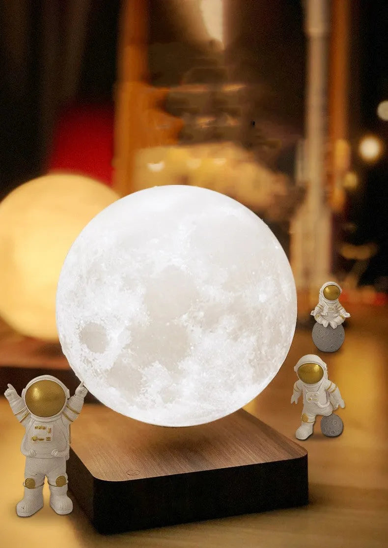 Floating magnetic levitation moon planet lamp with LED light and astronaut figures on desk