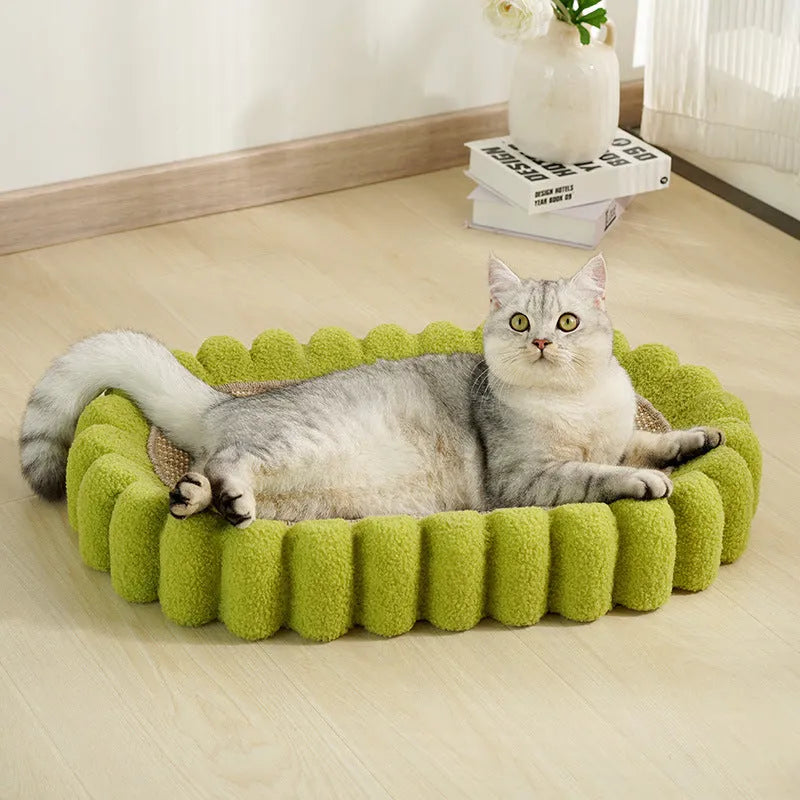 Green oval sisal cat scratching pad serving as a lounging bed, dimensions 650mm by 420mm.