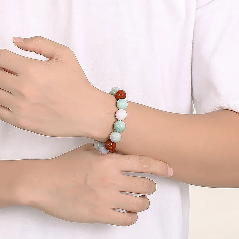 Women's Myanmar jade bracelet showing three-colour pattern on 13mm round beads.