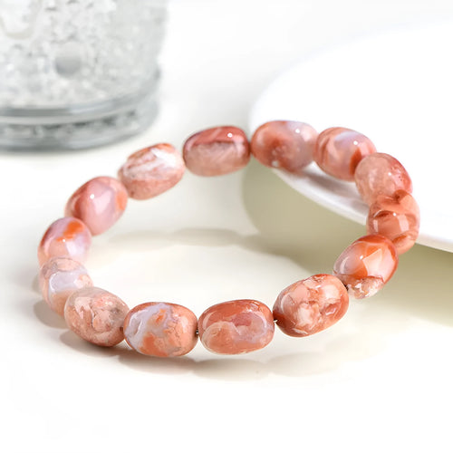 Natural cherry agate barrel bead bracelet with ruyi design elements measuring 10x14mm