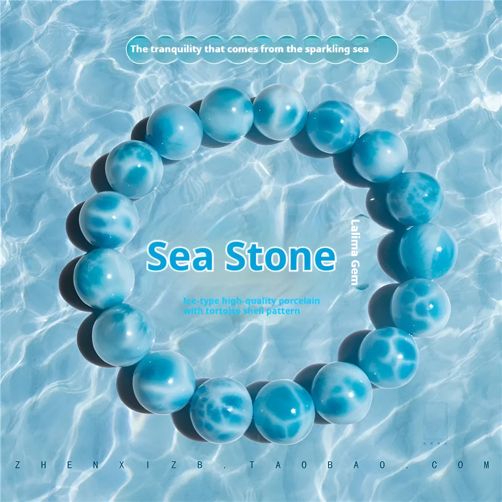 Blue Maillard style Bodhi bracelet with a natural sea-pattern crystal stone and pearl beads on wrist.