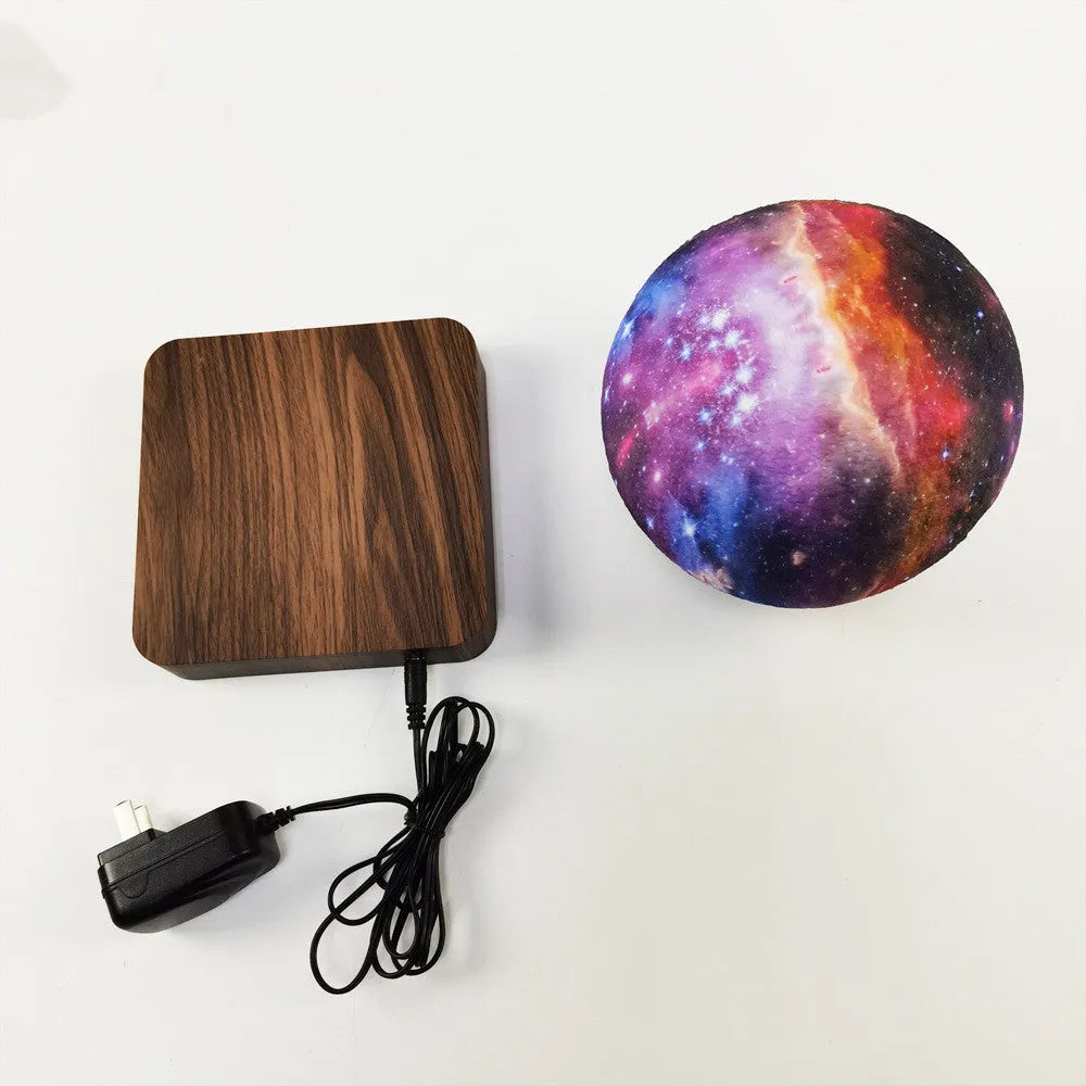 Magnetic levitation galaxy decorative light with floating moon lamp above walnut colour base