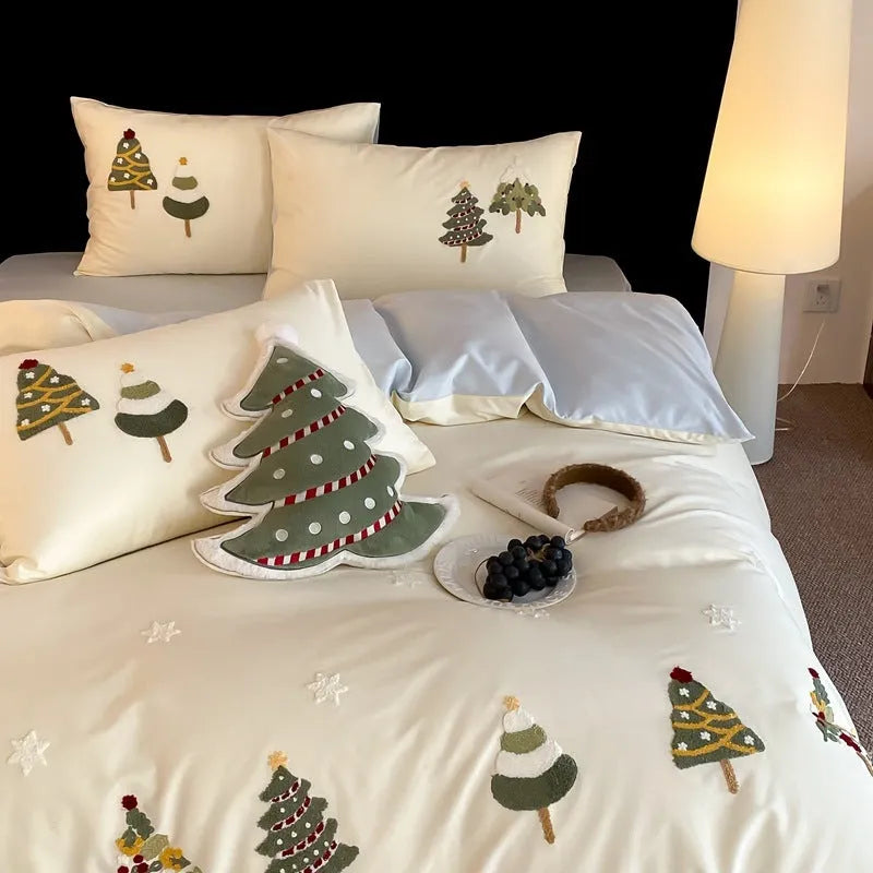 Cream blue Christmas tree embroidered pure cotton duvet cover, flat sheet, and pillowcases on a bed.