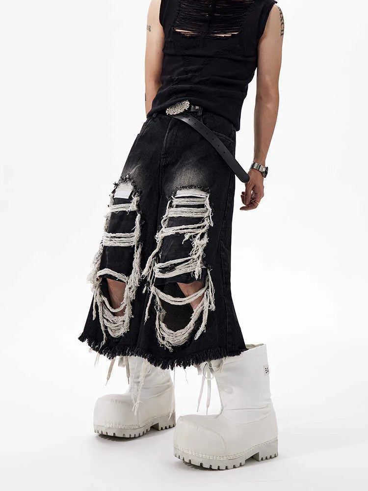 Black women's cropped wide leg jeans with a distressed patch detail on the leg.