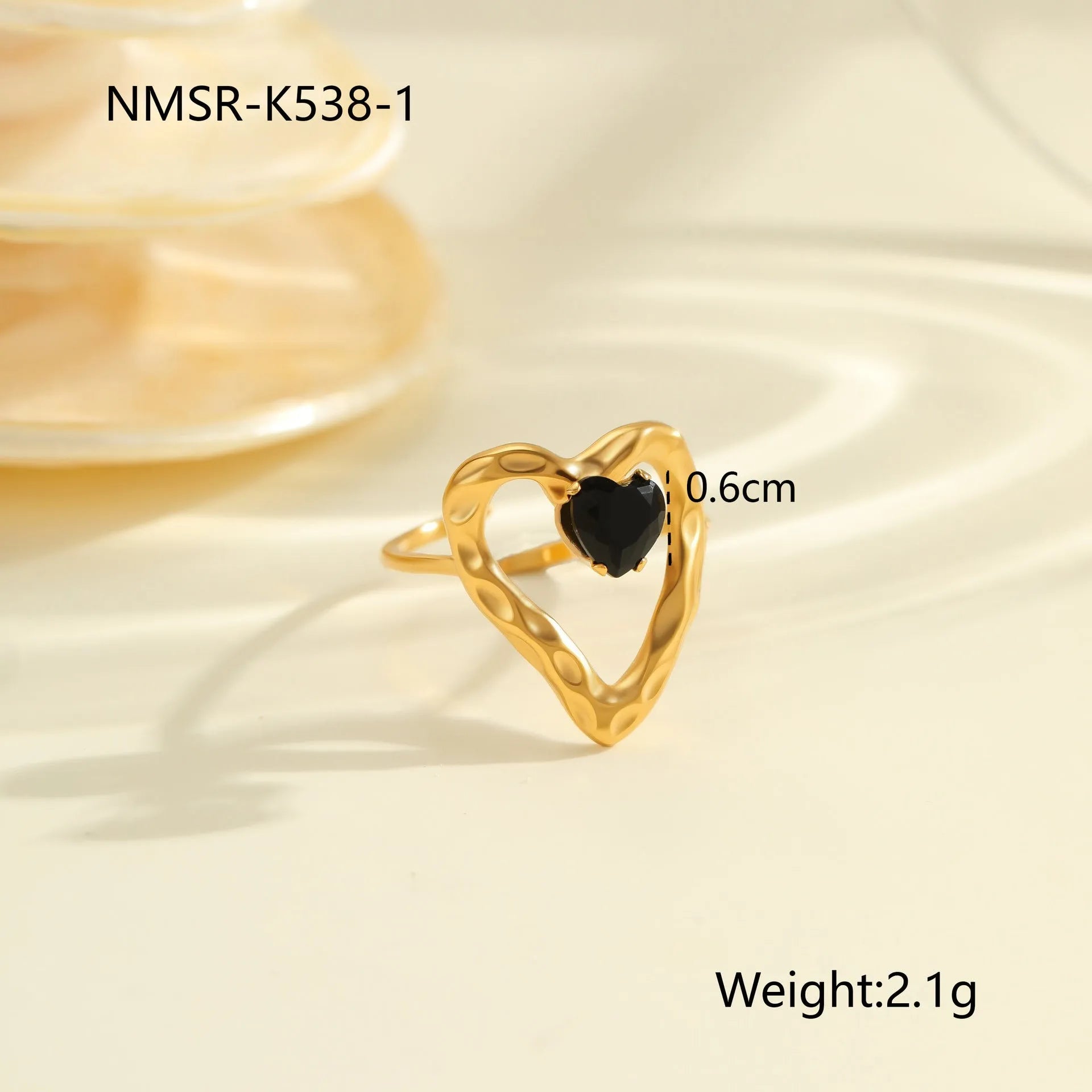 Geometric open mouth titanium steel ring for women on a plain background.