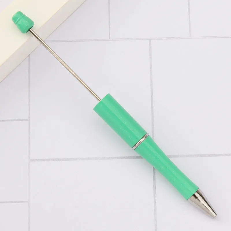 Creative ballpoint pen with multicoloured spinning plastic beads on a steel wire frame.