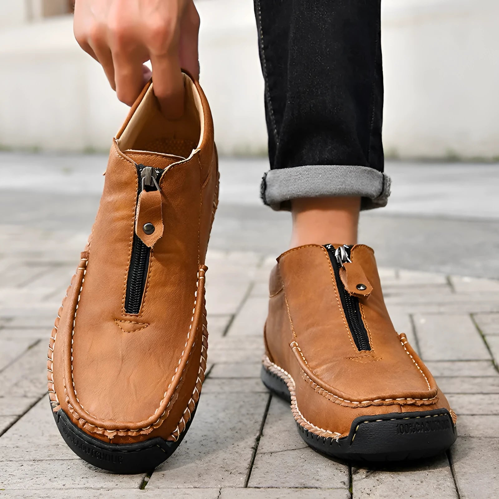 Men's black slip-on loafers with round toe and low heel design showing sewing detail on PU upper