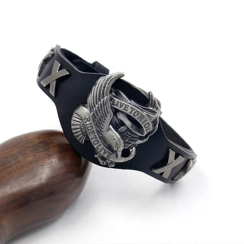 Black geometric bracelet with an alloy eagle watch-buttom on a leather strap.