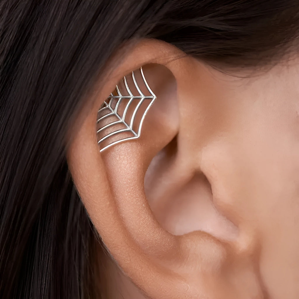 A pair of geometric spider web design stud earrings in an electroplated gold finish.