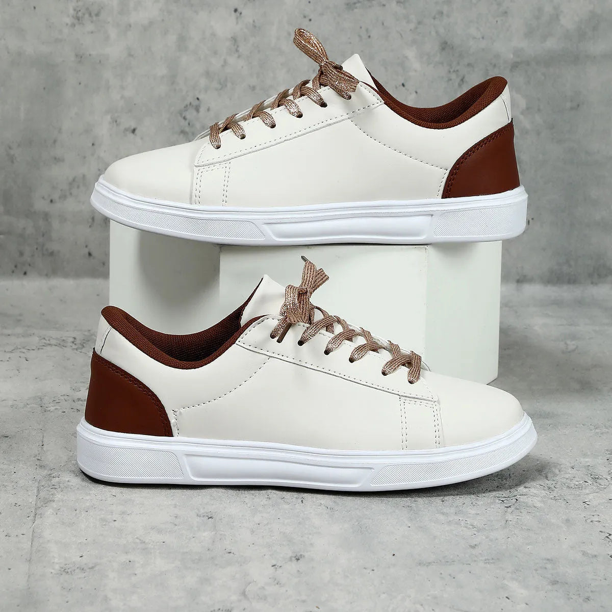 Low-top platform skate shoes with cross-strap detail and mid-heel design in beige brown colour