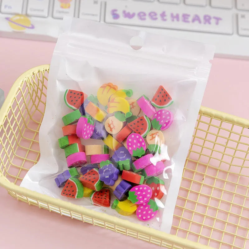 50 colourful cartoon mini erasers in pearlescent bags showing fruit, animal, and holiday designs