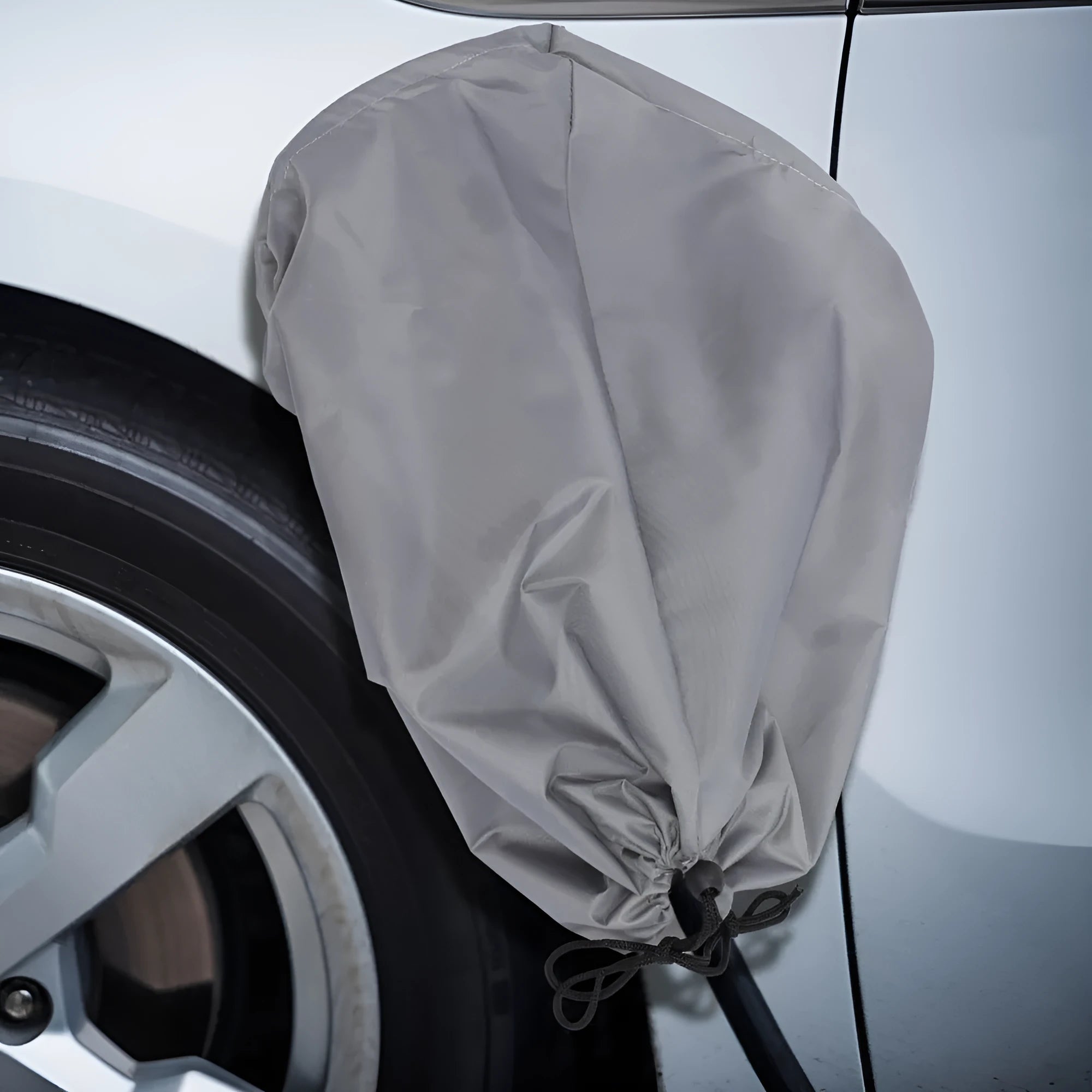 Waterproof charging port cover for new energy vehicles in grey with drawstring closure
