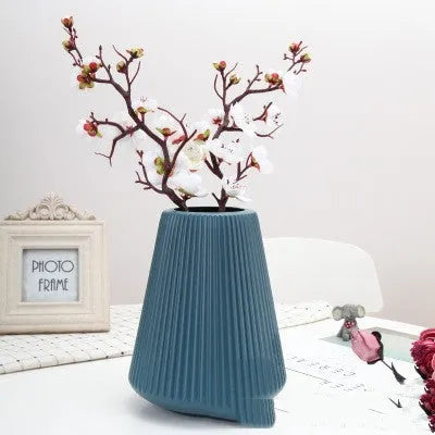 Melamine plastic decorative flower vase in blue colour on desktop