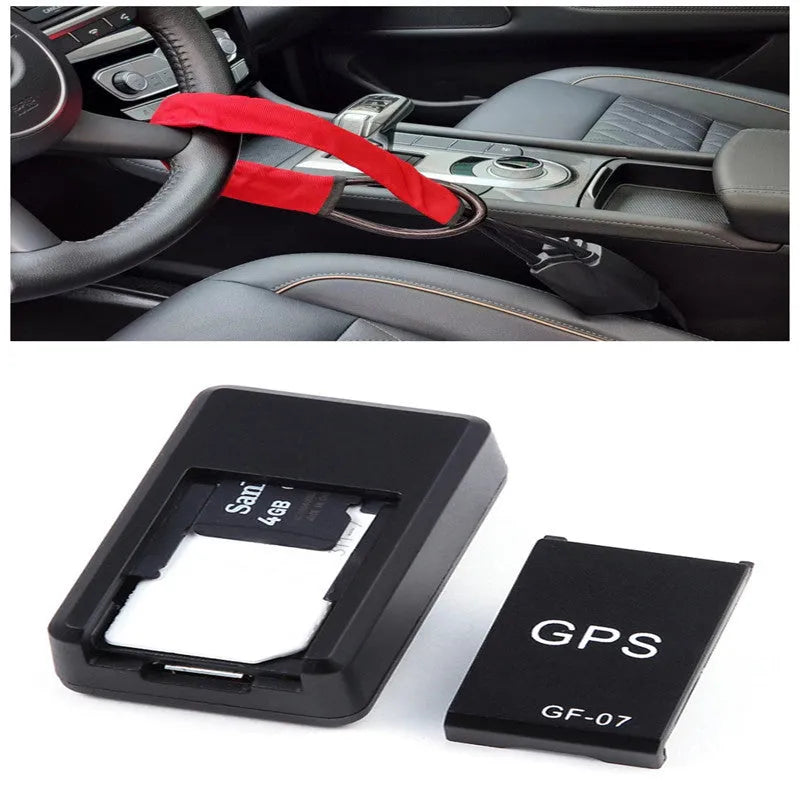 Small black plastic magnetic GPS car tracker device on a metal surface.