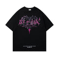 Man wearing a black loose fit cotton t-shirt with a retro graphic print on the chest.