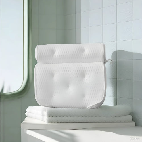 White 4D mesh bathtub pillow with suction cups, shown on bathtub edge.