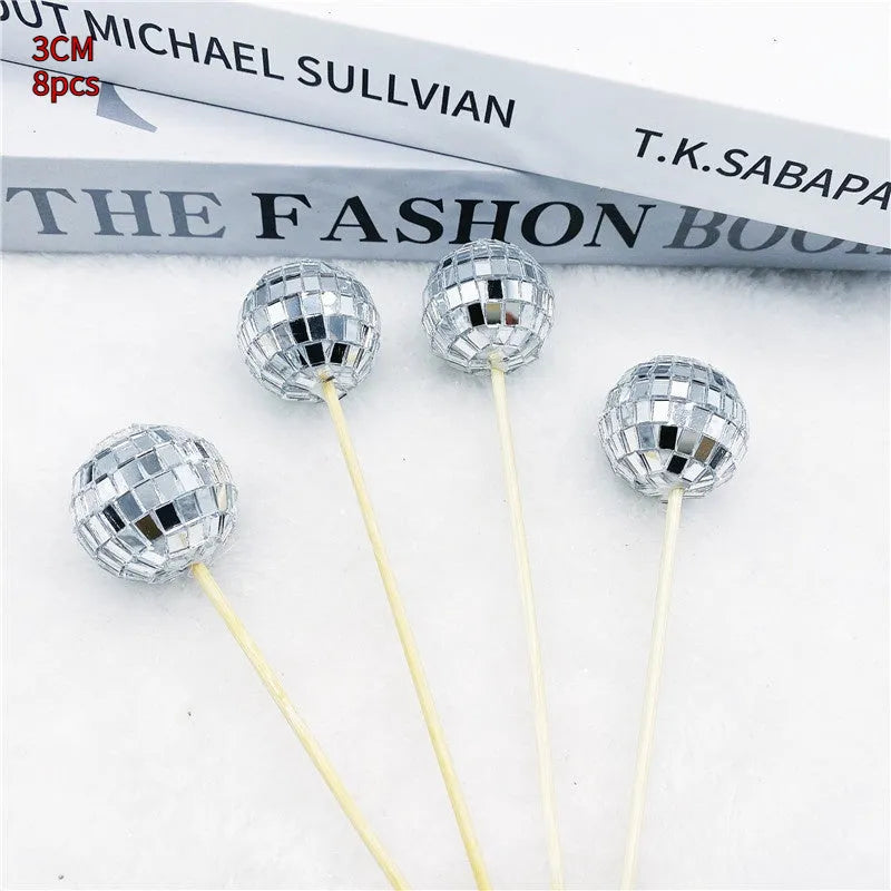 Glass disco ball cake decoration on a wooden stick, shown in different sizes for cake topping.