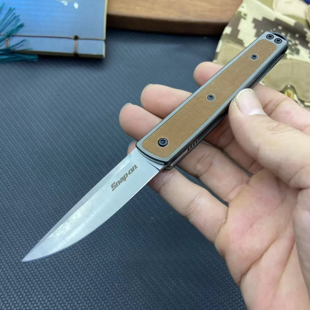 Closed and open views of a black folding fruit knife showing blade and handle.