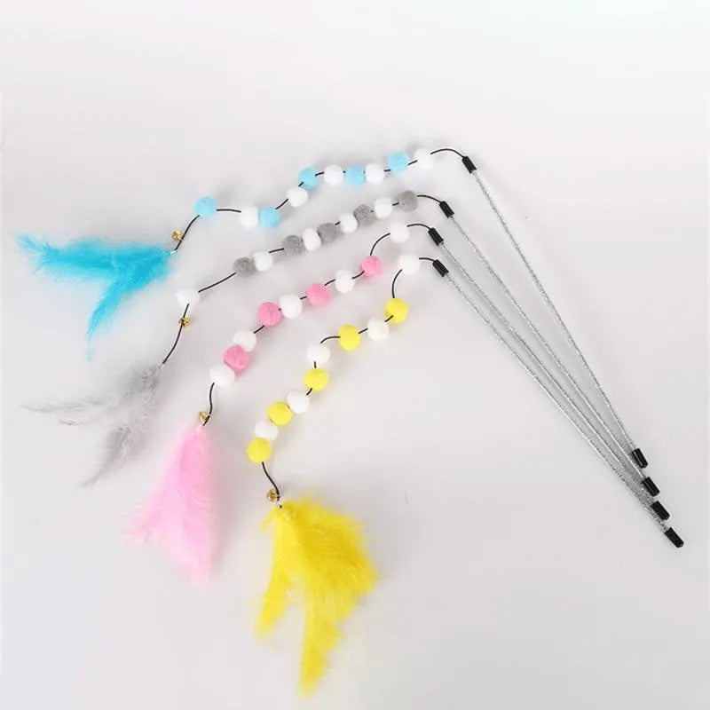 Grey and yellow cat teaser stick with a bell and a pompon feather, shown next to a blue and pink version.