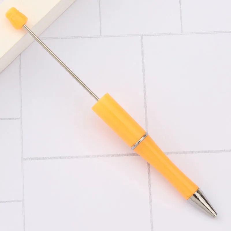 Creative ballpoint pen with multicoloured spinning plastic beads on a steel wire frame.