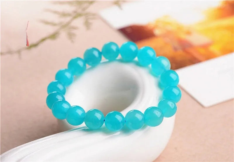 Natural blue-green amazonite scattered beads bracelet on wrist, showing polished stones and single circle design.